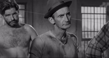 Movie still from “A Face in the Crowd” (1957), directed by Elia Kazan – An older man wearing a hat in a black and white photo; Medium shot, Low angle