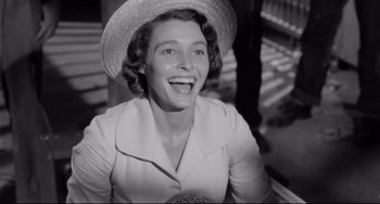 Movie still from “A Face in the Crowd” (1957), directed by Elia Kazan – An old photo of a woman wearing a straw hat; Close Up shot, High angle
