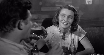 Movie still from “A Face in the Crowd” (1957), directed by Elia Kazan – Two women sitting at a table with a glass of wine; Medium shot, Low angle
