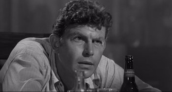 Movie still from “A Face in the Crowd” (1957), directed by Elia Kazan – A man sitting at a table with a drink in front of him; Close Up shot, High angle