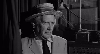 Movie still from “A Face in the Crowd” (1957), directed by Elia Kazan – An older man wearing a suit and a hat; Close Up shot, Over the shoulder angle