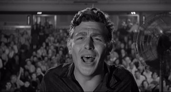 Movie still from “A Face in the Crowd” (1957), directed by Elia Kazan – A man with his mouth wide open in front of an audience; Close Up shot, High angle