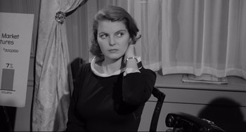 Movie still from “A Face in the Crowd” (1957), directed by Elia Kazan – A black - and - white photo of a woman in a black dress; Close Up shot, Over the shoulder angle