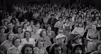 Movie still from “A Face in the Crowd” (1957), directed by Elia Kazan – A large group of people sitting in front of a crowd; Wide shot, High angle