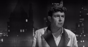 Movie still from “A Face in the Crowd” (1957), directed by Elia Kazan – Black and white photograph of a man wearing a suit and tie; Close Up shot, Low angle