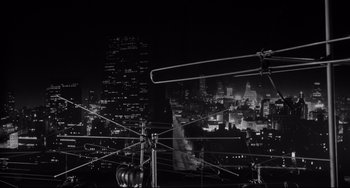 Movie still from “A Face in the Crowd” (1957), directed by Elia Kazan – A black and white photo of a city at night; Extreme Wide shot, Low angle