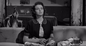 Movie still from “A Face in the Crowd” (1957), directed by Elia Kazan – A woman sitting on a couch in a living room; Medium shot, Low angle