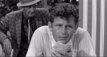 Movie still from “A Face in the Crowd” (1957), directed by Elia Kazan – A black and white photo of a man holding a piece of paper; Close Up shot, Over the shoulder angle
