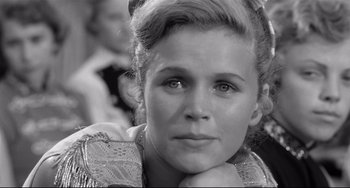 Movie still from “A Face in the Crowd” (1957), directed by Elia Kazan – A young woman is sitting with her head resting on her hands; Close Up shot, Over the shoulder angle