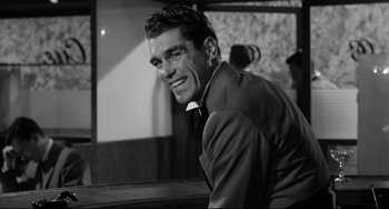 Movie still from “A Face in the Crowd” (1957), directed by Elia Kazan – Black and white photograph of a man smiling; Close Up shot, Low angle