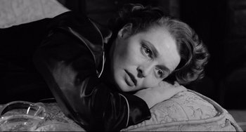 Movie still from “A Face in the Crowd” (1957), directed by Elia Kazan – Black and white photograph of a woman laying on a bed; Close Up shot, High angle