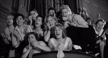 Movie still from “A Face in the Crowd” (1957), directed by Elia Kazan – A group of people sitting in a room; Medium shot, High angle