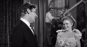 Movie still from “A Face in the Crowd” (1957), directed by Elia Kazan – A black and white photo of a man and a woman; Medium shot, Over the shoulder angle