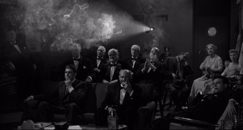 Movie still from “A Face in the Crowd” (1957), directed by Elia Kazan – A group of men sitting in a room smoking cigarettes; Wide shot, High angle