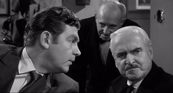 Movie still from “A Face in the Crowd” (1957), directed by Elia Kazan – A group of men standing next to each other in a room; Close Up shot, Over the shoulder angle