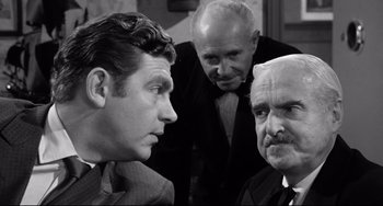 Movie still from “A Face in the Crowd” (1957), directed by Elia Kazan – A group of men standing next to each other in a room; Close Up shot, Over the shoulder angle