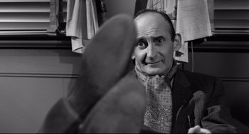 Movie still from “A Face in the Crowd” (1957), directed by Elia Kazan – A black and white photo of a man wearing a scarf; Close Up shot, Low angle