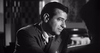 Movie still from “A Face in the Crowd” (1957), directed by Elia Kazan – Black and white photograph of a man wearing a suit and tie; Close Up shot, Low angle