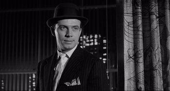 Movie still from “A Face in the Crowd” (1957), directed by Elia Kazan – A black and white photo of a man wearing a suit and hat; Close Up shot, Low angle