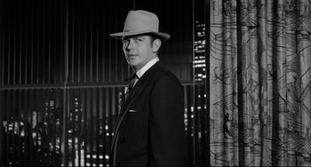 Movie still from “A Face in the Crowd” (1957), directed by Elia Kazan – A black and white photo of a man in a suit and a hat; Medium shot, Low angle