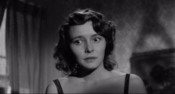 Movie still from “A Face in the Crowd” (1957), directed by Elia Kazan – A black - and - white photo of a woman in a black dress; Close Up shot, Low angle