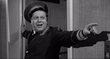 Movie still from “A Face in the Crowd” (1957), directed by Elia Kazan – A black and white photo of a man in a uniform; Medium shot, Low angle