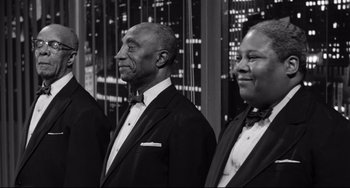 Movie still from “A Face in the Crowd” (1957), directed by Elia Kazan – A black and white photo of three men in tuxedos; Medium shot, Low angle