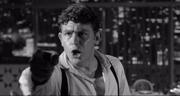 Movie still from “A Face in the Crowd” (1957), directed by Elia Kazan – A black - and - white photo of a man with a surprised look on his face; Close Up shot, Low angle