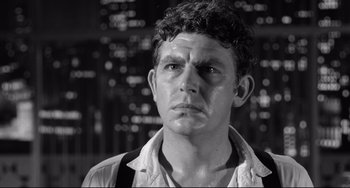 Movie still from “A Face in the Crowd” (1957), directed by Elia Kazan – Black and white photograph of a man in front of a city skyline; Close Up shot, Low angle