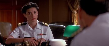 Movie still from “A Few Good Men” (1992), directed by Rob Reiner – A woman sitting in a chair wearing a naval uniform; Close Up shot, Over the shoulder angle