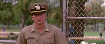 Movie still from “A Few Good Men” (1992), directed by Rob Reiner – A man in a military uniform standing in front of a fence; Close Up shot, Low angle