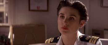 Movie still from “A Few Good Men” (1992), directed by Rob Reiner – A woman in a military uniform looking to her left; Close Up shot, Over the shoulder angle