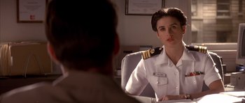 Movie still from “A Few Good Men” (1992), directed by Rob Reiner – A woman in a uniform sitting in front of a man; Close Up shot, Over the shoulder angle