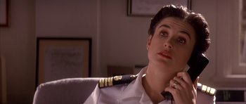 Movie still from “A Few Good Men” (1992), directed by Rob Reiner – A woman in a uniform talking on a phone; Close Up shot, Low angle