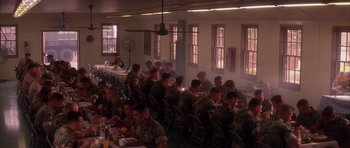 Movie still from “A Few Good Men” (1992), directed by Rob Reiner – A large group of soldiers sitting at a long table eating food; Wide shot, High angle