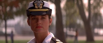 Movie still from “A Few Good Men” (1992), directed by Rob Reiner – A woman in a military uniform is standing in front of a tree; Close Up shot, Low angle
