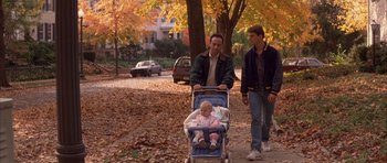 Movie still from “A Few Good Men” (1992), directed by Rob Reiner – A man pushing a baby in a stroller while another man walks by; Wide shot, High angle