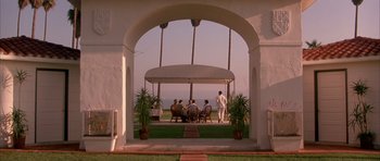 Movie still from “A Few Good Men” (1992), directed by Rob Reiner – A group of people sitting under an awning on a lawn; Extreme Wide shot, High angle