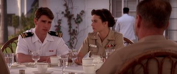 Movie still from “A Few Good Men” (1992), directed by Rob Reiner – A woman sitting at a table with a man in a uniform; Medium shot, Over the shoulder angle
