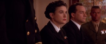 Movie still from “A Few Good Men” (1992), directed by Rob Reiner – A woman in a military uniform looking to her left; Close Up shot, Over the shoulder angle