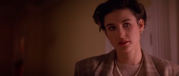 Movie still from “A Few Good Men” (1992), directed by Rob Reiner – A person wearing a suit and pearls; Close Up shot, Over the shoulder angle