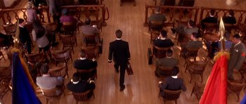 Movie still from “A Few Good Men” (1992), directed by Rob Reiner – A man in a suit walks down a wooden aisle; Wide shot, High angle