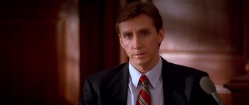 Movie still from “A Few Good Men” (1992), directed by Rob Reiner – A person wearing a suit and tie; Close Up shot, Over the shoulder angle