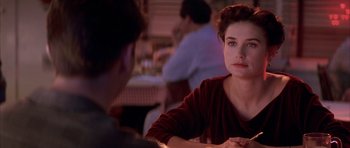 Movie still from “A Few Good Men” (1992), directed by Rob Reiner – A woman sitting in front of a man at a table; Close Up shot, Over the shoulder angle