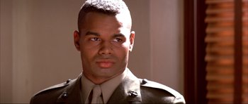 Movie still from “A Few Good Men” (1992), directed by Rob Reiner – A person wearing a military uniform; Close Up shot, Low angle