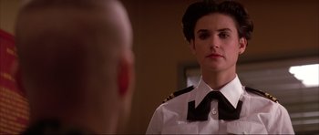 Movie still from “A Few Good Men” (1992), directed by Rob Reiner – A woman in a uniform looking into a mirror; Close Up shot, Over the shoulder angle