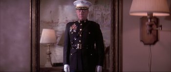 Movie still from “A Few Good Men” (1992), directed by Rob Reiner – A man in a military uniform standing in front of a painting; Medium shot, Low angle