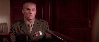 Movie still from “A Few Good Men” (1992), directed by Rob Reiner – A man in a military uniform sitting in front of microphones; Close Up shot, Low angle