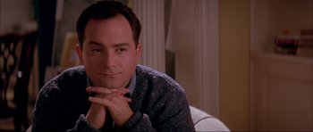 Movie still from “A Few Good Men” (1992), directed by Rob Reiner – A person sitting on a couch with his hands under his chin; Close Up shot, Low angle