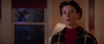 Movie still from “A Few Good Men” (1992), directed by Rob Reiner – A woman in a red shirt and plaid shirt; Close Up shot, Over the shoulder angle